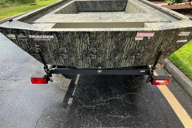 Slide: The Image of 2026 Tracker Grizzly 1754 Utility boat with camouflage design on a trailer. - 3