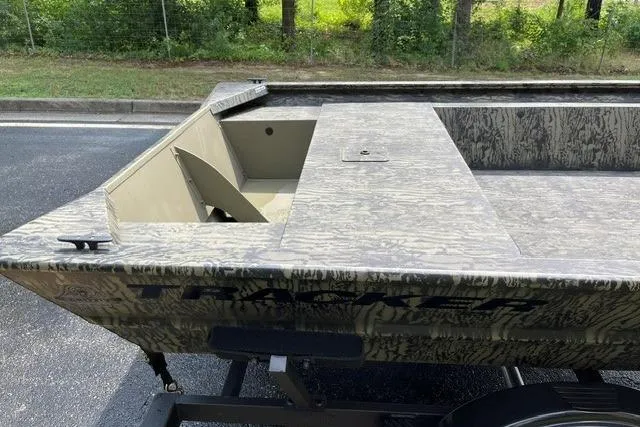 Slide: The Image of 2026 Tracker Grizzly 1754 Utility boat with camouflage design, parked on a trailer. - 5