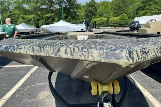 Slide: The Image of 2026 Tracker Grizzly 1754 Utility boat with camouflage pattern, displayed outdoors. - 8