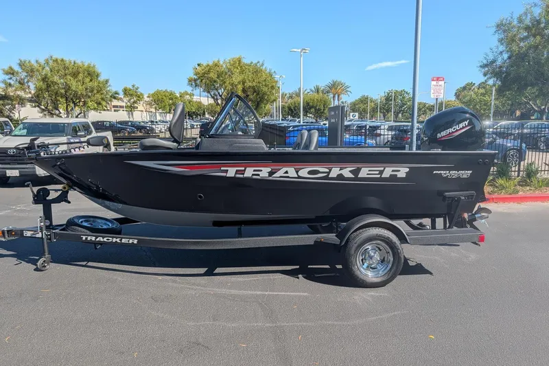 Slide: The Image of 2026 Tracker Pro Guide V-175 Combo boat displayed indoors on a trailer. - 5