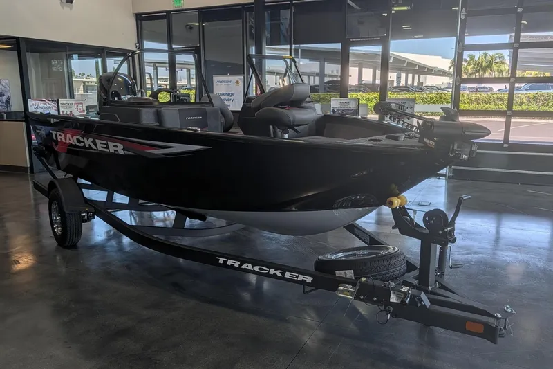 Slide: The Image of 2026 Tracker Pro Guide V-175 Combo boat displayed indoors on a trailer. - 9