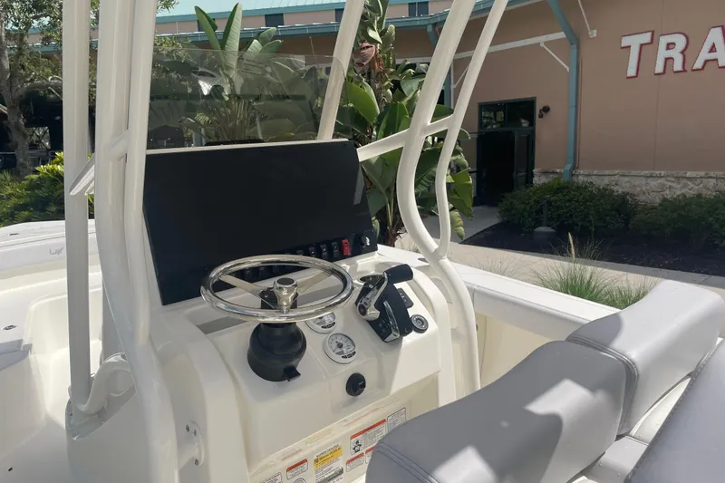 Slide: The Image of 2026 Mako 226 Center Console boat interior with steering wheel and control panel. - 11