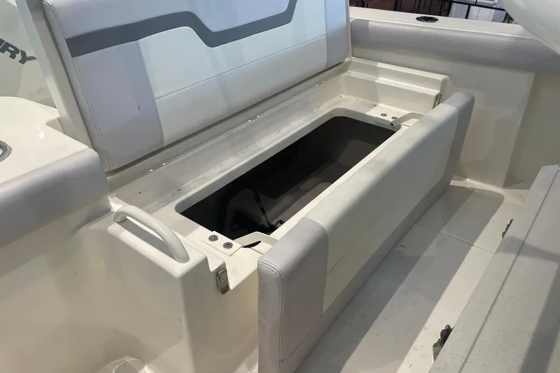 Slide: The Image of 2026 Mako 226 Center Console boat with open storage compartment and cushioned seating. - 8