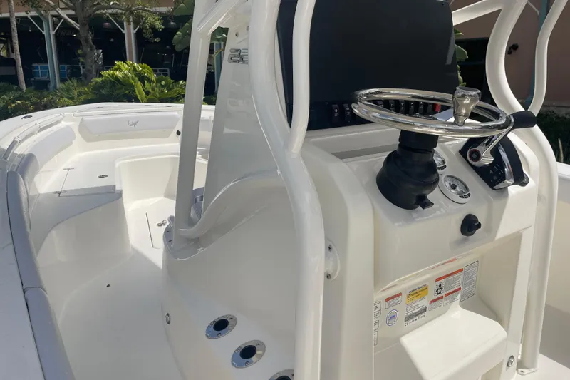 Slide: The Image of 2026 Mako 226 Center Console boat interior with steering wheel and seating area. - 12