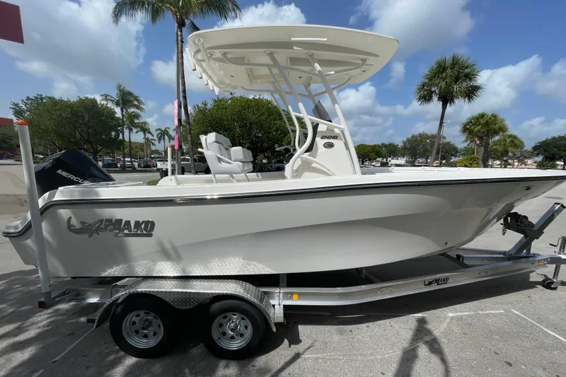 Slide: The Image of 2026 Mako 226 Center Console boat on trailer, parked outdoors under blue sky. - 0