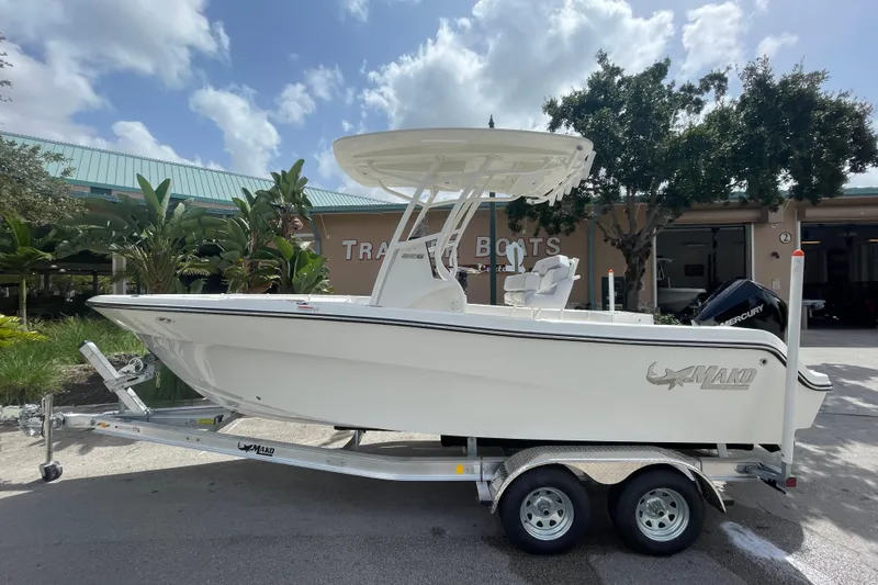 Slide: The Image of 2026 Mako 226 Center Console boat on trailer, parked outdoors under a cloudy sky. - 1