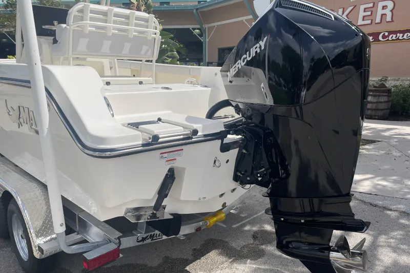 Slide: The Image of 2026 Mako 226 Center Console boat with Mercury outboard motor, parked on a trailer. - 2