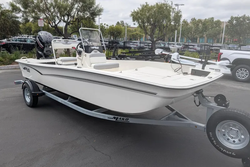 The Image of 2026 Mako Pro Skiff 17 CC boat on trailer, parked outdoors. - 0