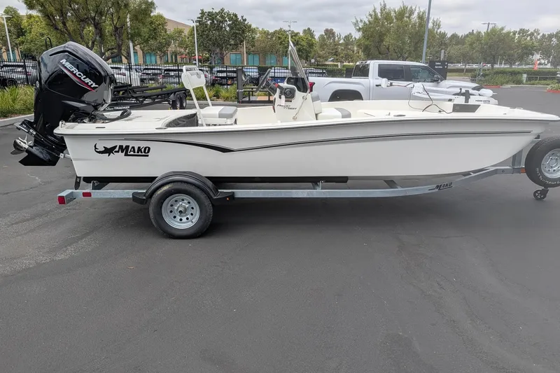 Slide: The Image of 2026 Mako Pro Skiff 17 CC boat on trailer, parked outdoors. - 1