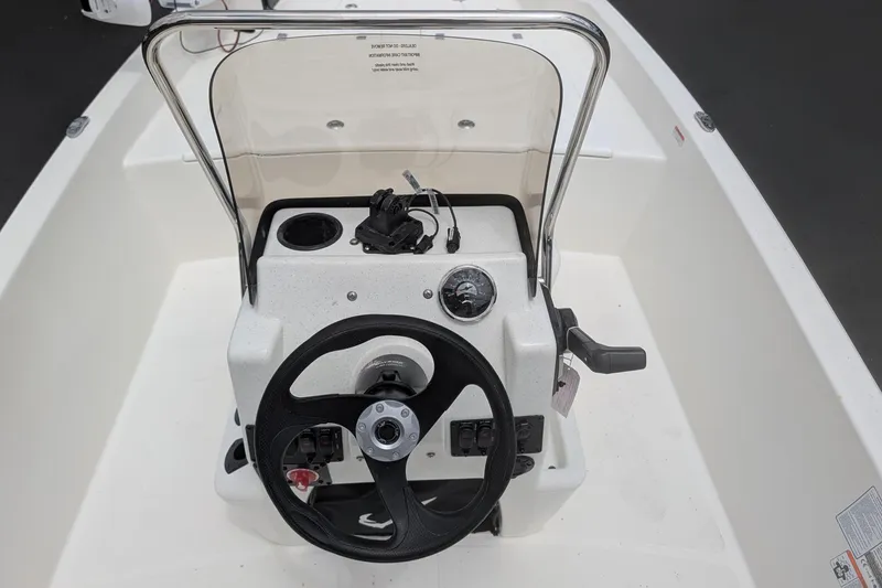 Slide: The Image of 2026 Mako Pro Skiff 17 CC boat console with steering wheel and controls. - 10