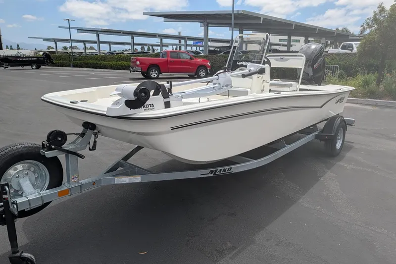 Slide: The Image of 2026 Mako Pro Skiff 17 CC boat on trailer in parking lot, sunny day. - 4