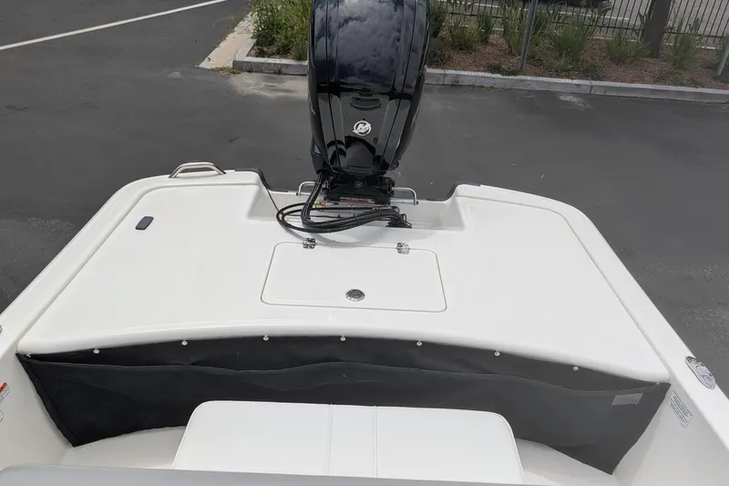 Slide: The Image of 2026 Mako Pro Skiff 17 CC boat with outboard motor in parking lot. - 5