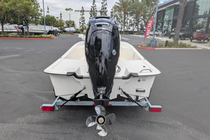 Slide: The Image of 2026 Mako Pro Skiff 17 CC boat on trailer, rear view with outboard motor. - 6