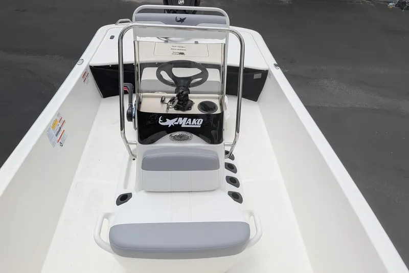 Slide: The Image of 2026 Mako Pro Skiff 17 CC boat interior with steering console and seating. - 7
