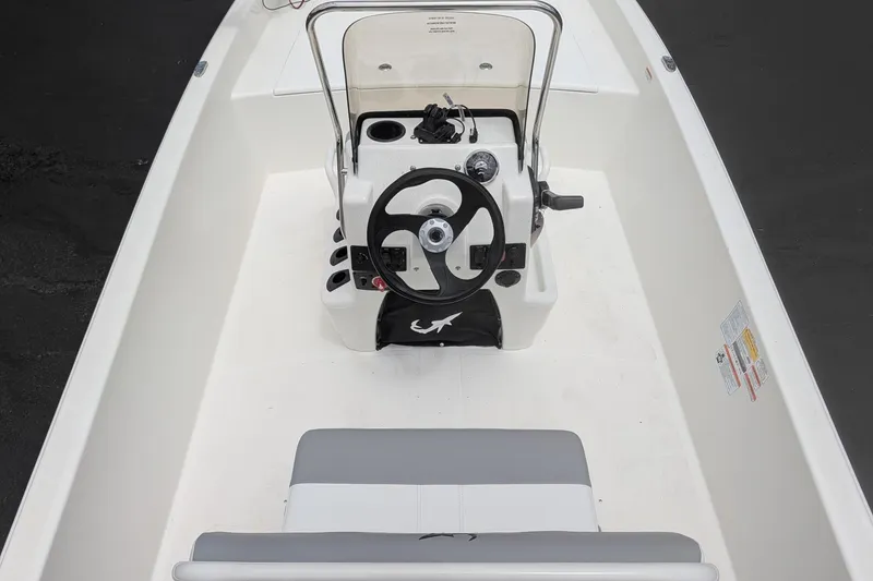 Slide: The Image of 2026 Mako Pro Skiff 17 CC boat interior with steering console and seating. - 8