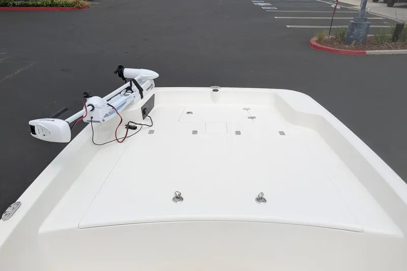 Slide: The Image of 2026 Mako Pro Skiff 17 CC boat deck with trolling motor in parking lot. - 9