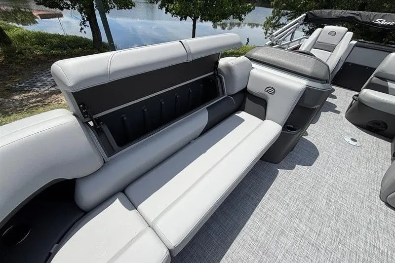 Slide: The Image of 2026 Sun Tracker SportFish 20 DLX boat interior with gray seating and storage compartment. - 11