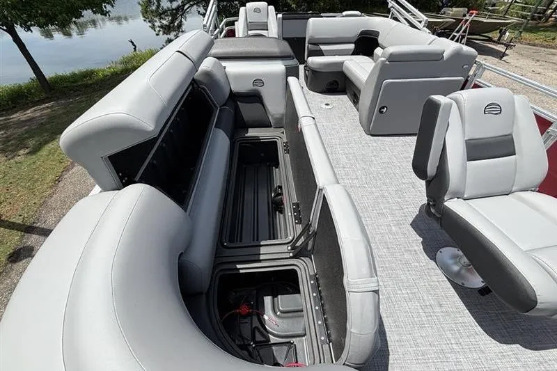 Slide: The Image of 2026 Sun Tracker SportFish 20 DLX pontoon boat interior with gray seating and storage compartments. - 12