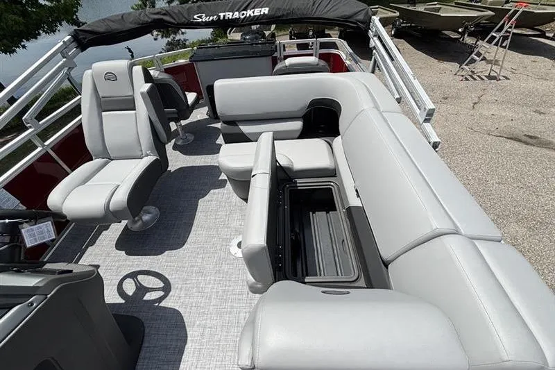 Slide: The Image of Interior of 2026 Sun Tracker SportFish 20 DLX pontoon boat with gray seating and storage. - 14