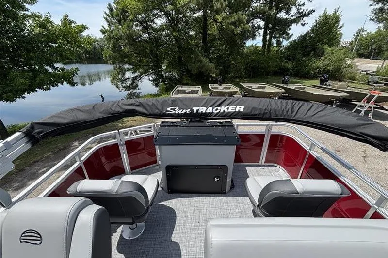Slide: The Image of 2026 Sun Tracker SportFish 20 DLX pontoon boat interior with seating and covered console. - 15