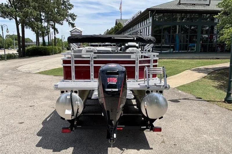 Slide: The Image of 2026 Sun Tracker SportFish 20 DLX pontoon boat with Mercury 115 outboard motor, parked outdoors. - 3
