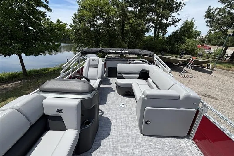 Slide: The Image of 2026 Sun Tracker SportFish 20 DLX pontoon boat with spacious seating and scenic lake view. - 6