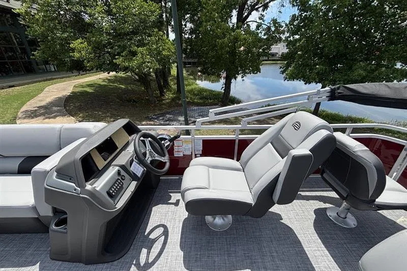 Slide: The Image of 2026 Sun Tracker SportFish 20 DLX pontoon boat interior with steering console and seating. - 8