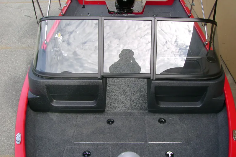 Slide: The Image of 2026 Tracker Pro Guide V-16 WT boat interior with windshield and carpeted deck. - 5