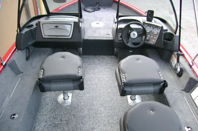 Slide: The Image of 2026 Tracker Pro Guide V-16 WT boat interior with steering console and seating. - 6