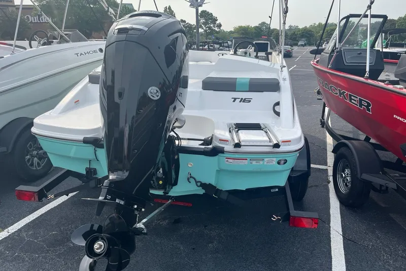 Slide: The Image of 2026 Tahoe T16 boat with outboard motor, parked on a trailer in a lot. - 4