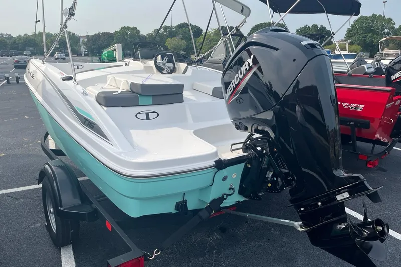 Slide: The Image of 2026 Tahoe T16 boat with Mercury outboard motor on trailer in parking lot. - 3