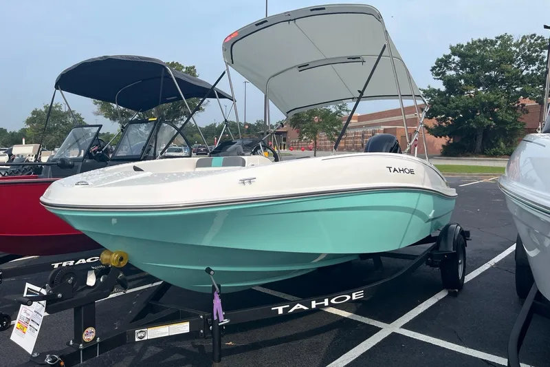 The Image of 2026 Tahoe T16 boat with canopy on trailer in parking lot. - 0