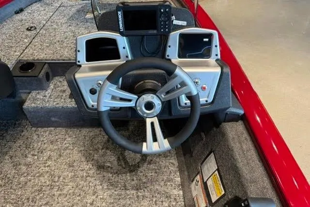 Slide: The Image of 2026 Tracker Pro Team 175 boat dashboard with steering wheel and navigation system. - 2