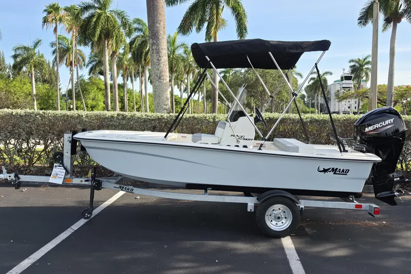 The Image of 2026 Mako Pro Skiff 13 CC boat on trailer, parked with palm trees in background. - 0