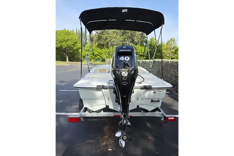 Slide: The Image of 2026 Mako Pro Skiff 13 CC with Mercury 40 outboard motor, parked on a trailer. - 10