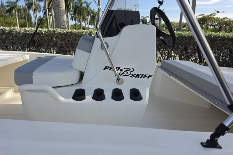 Slide: The Image of 2026 Mako Pro Skiff 13 CC boat interior with seating and steering console. - 4