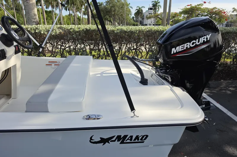 Slide: The Image of 2026 Mako Pro Skiff 13 CC boat with Mercury engine, parked outdoors. - 6