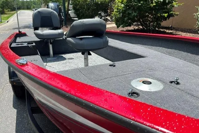 Slide: The Image of Red 2026 Tracker Super Guide V-16 T boat with dual seats and carpeted deck. - 4
