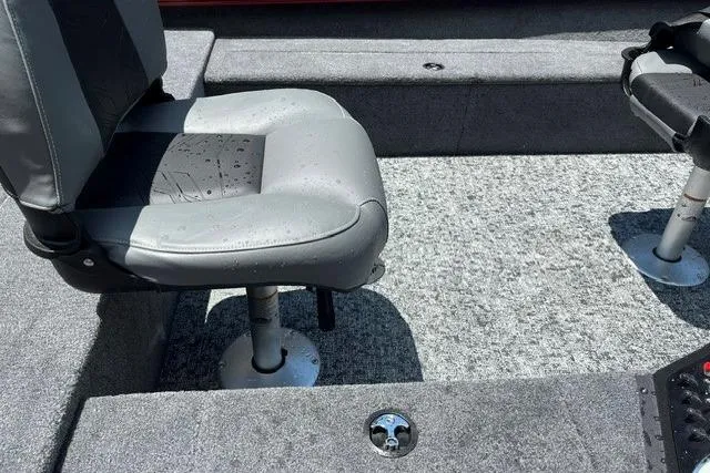 Slide: The Image of Interior of 2026 Tracker Super Guide V-16 T boat with gray seating and carpeted flooring. - 9