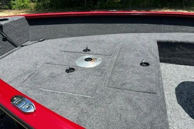 Slide: The Image of 2026 Tracker Super Guide V-16 T boat interior with gray carpet and red trim. - 11