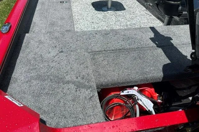 Slide: The Image of 2026 Tracker Super Guide V-16 T boat interior with red accents and storage compartment. - 8