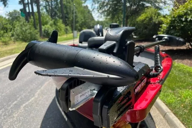 Slide: The Image of 2026 Tracker Super Guide V-16 T boat with trolling motor, parked on a sunny day. - 2