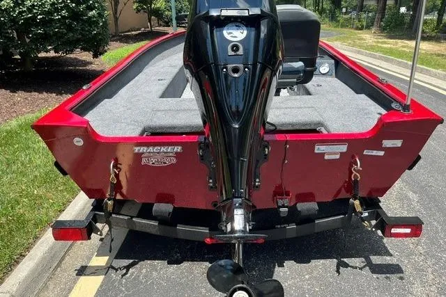 Slide: The Image of 2026 Tracker Super Guide V-16 T boat, red exterior, parked on a sunny day. - 3