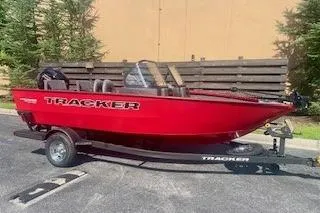 The Image of 2026 Tracker Pro Guide V-175 Combo boat, red, on trailer, parked outdoors. - 0