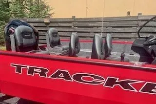 Slide: The Image of 2026 Tracker Pro Guide V-175 Combo boat with red exterior and comfortable seating. - 2