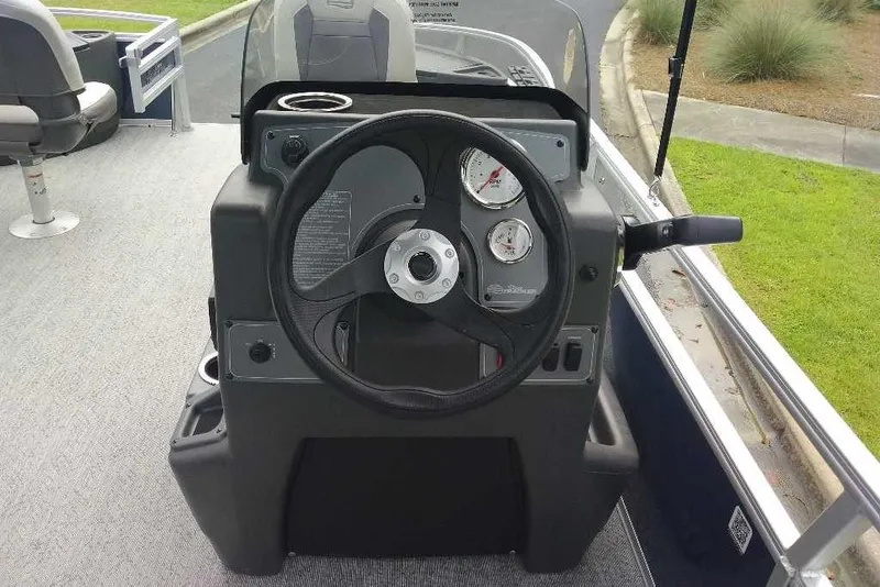 Slide: The Image of 2026 Sun Tracker Bass Buggy 18 DLX steering console with gauges and controls. - 1