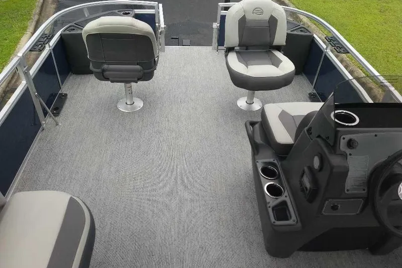 Slide: The Image of 2026 Sun Tracker Bass Buggy 18 DLX pontoon boat interior with seating and console. - 3