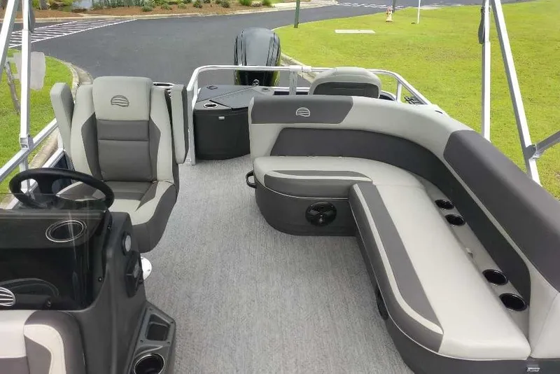 Slide: The Image of 2026 Sun Tracker Bass Buggy 18 DLX pontoon boat interior with seating and steering console. - 4