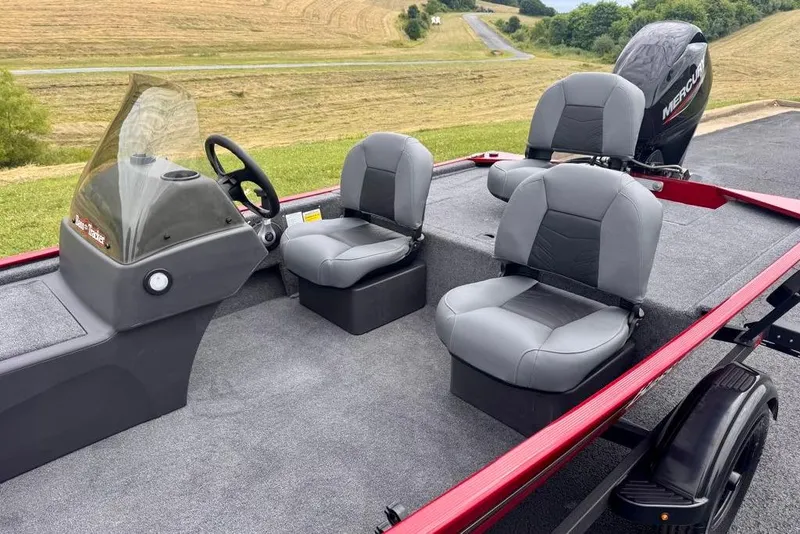 Slide: The Image of 2026 Tracker Bass Tracker Classic XL boat interior with gray seating and steering console. - 10