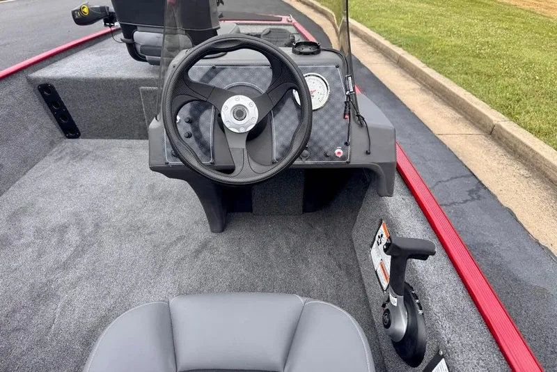 Slide: The Image of 2026 Tracker Bass Tracker Classic XL boat interior with steering wheel and control panel. - 9